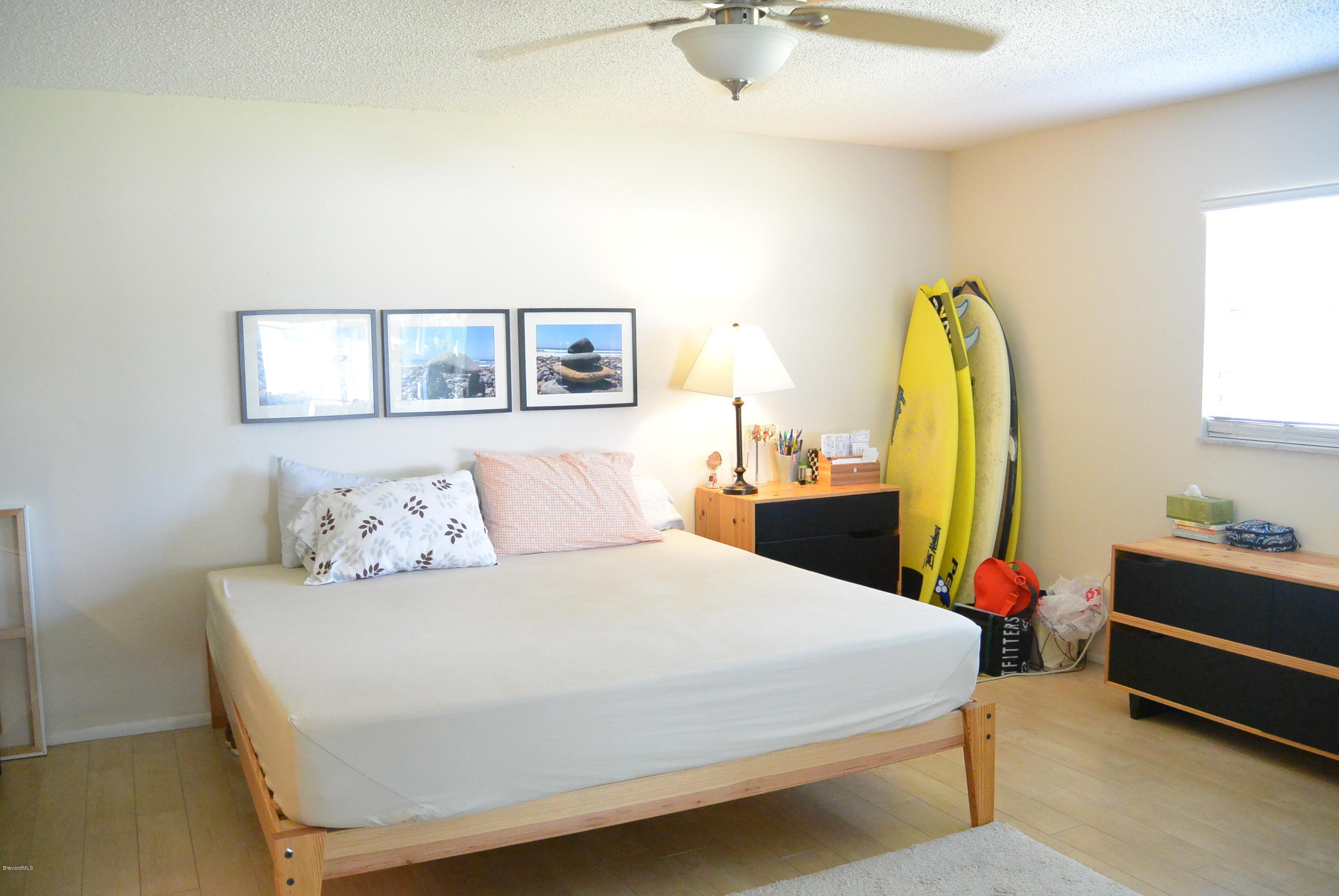 9 West Point Drive Cocoa Beach, FL 32931 - Photo 19 of 28 a bedroom with a bed and wooden floor