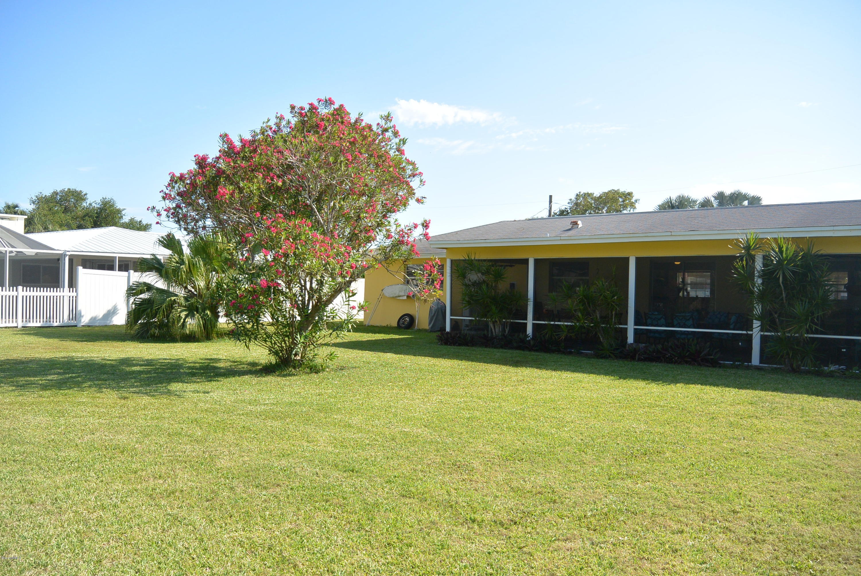 9 West Point Drive Cocoa Beach, FL 32931 - Photo 22 of 28 a view of a house with a yard and a large tree