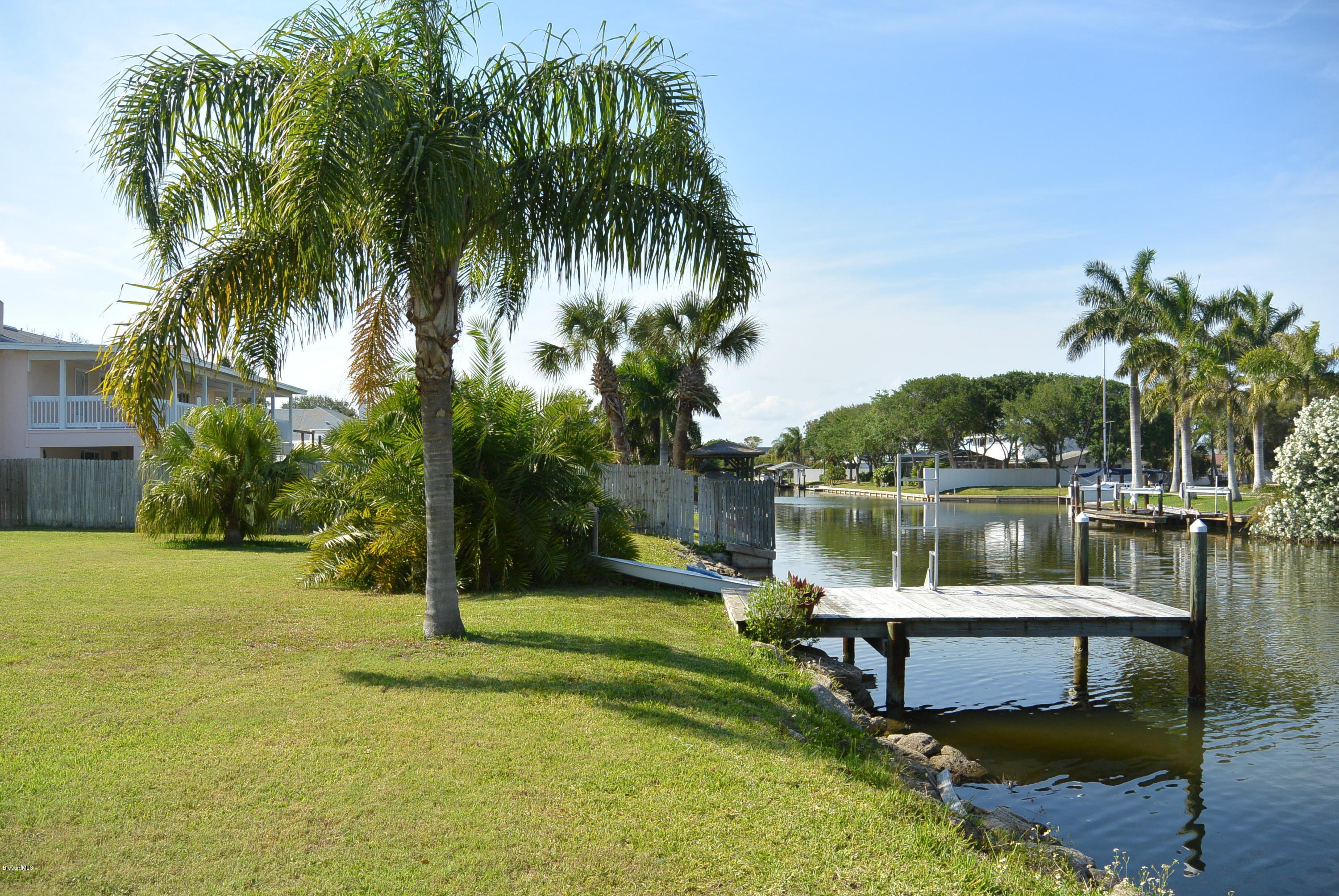 9 West Point Drive Cocoa Beach, FL 32931 - Photo 25 of 28 a view of a lake with a house in the background
