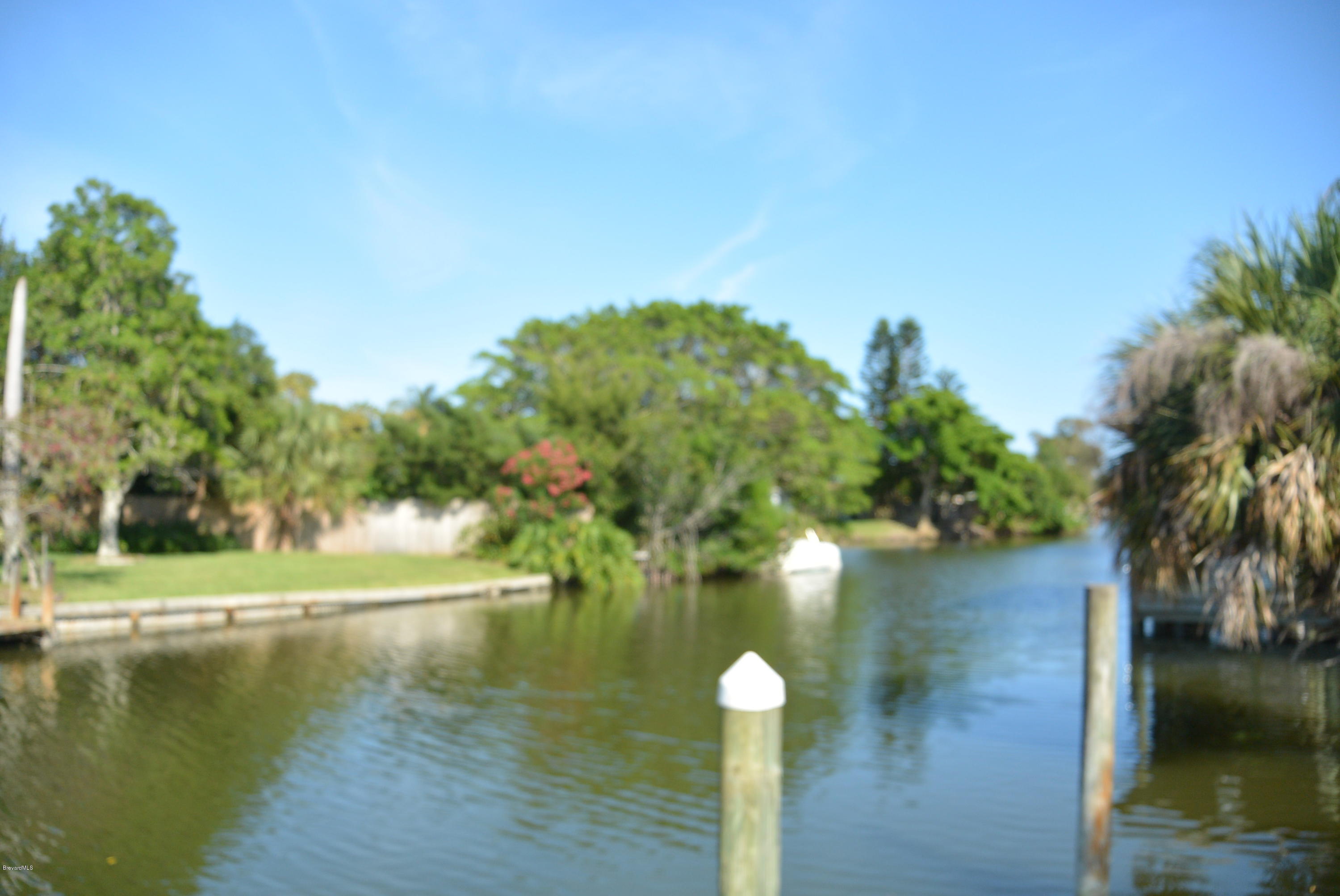 9 West Point Drive Cocoa Beach, FL 32931 - Photo 27 of 28 a view of a lake with a yard