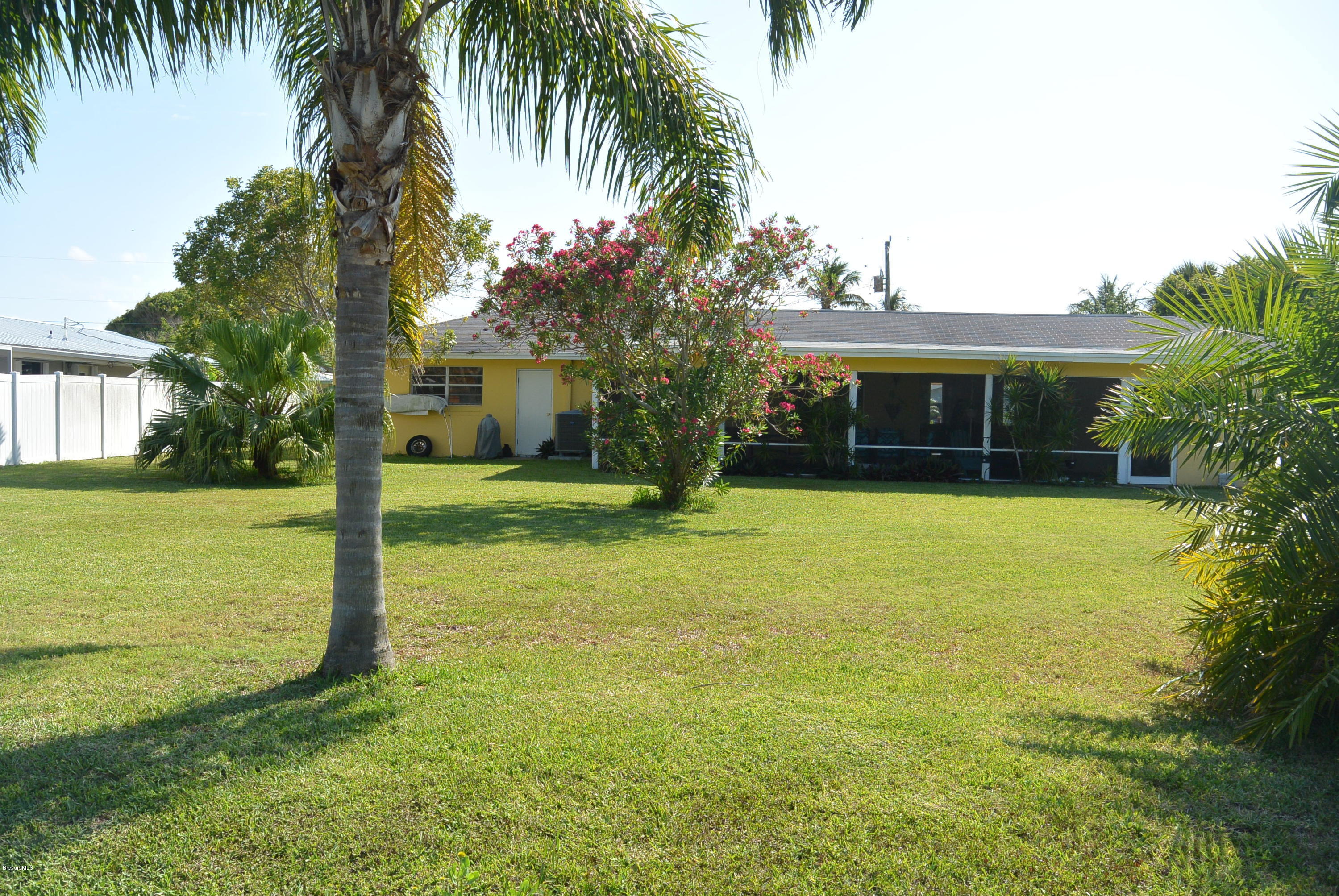 9 West Point Drive Cocoa Beach, FL 32931 - Photo 28 of 28 a front view of house with yard and green space