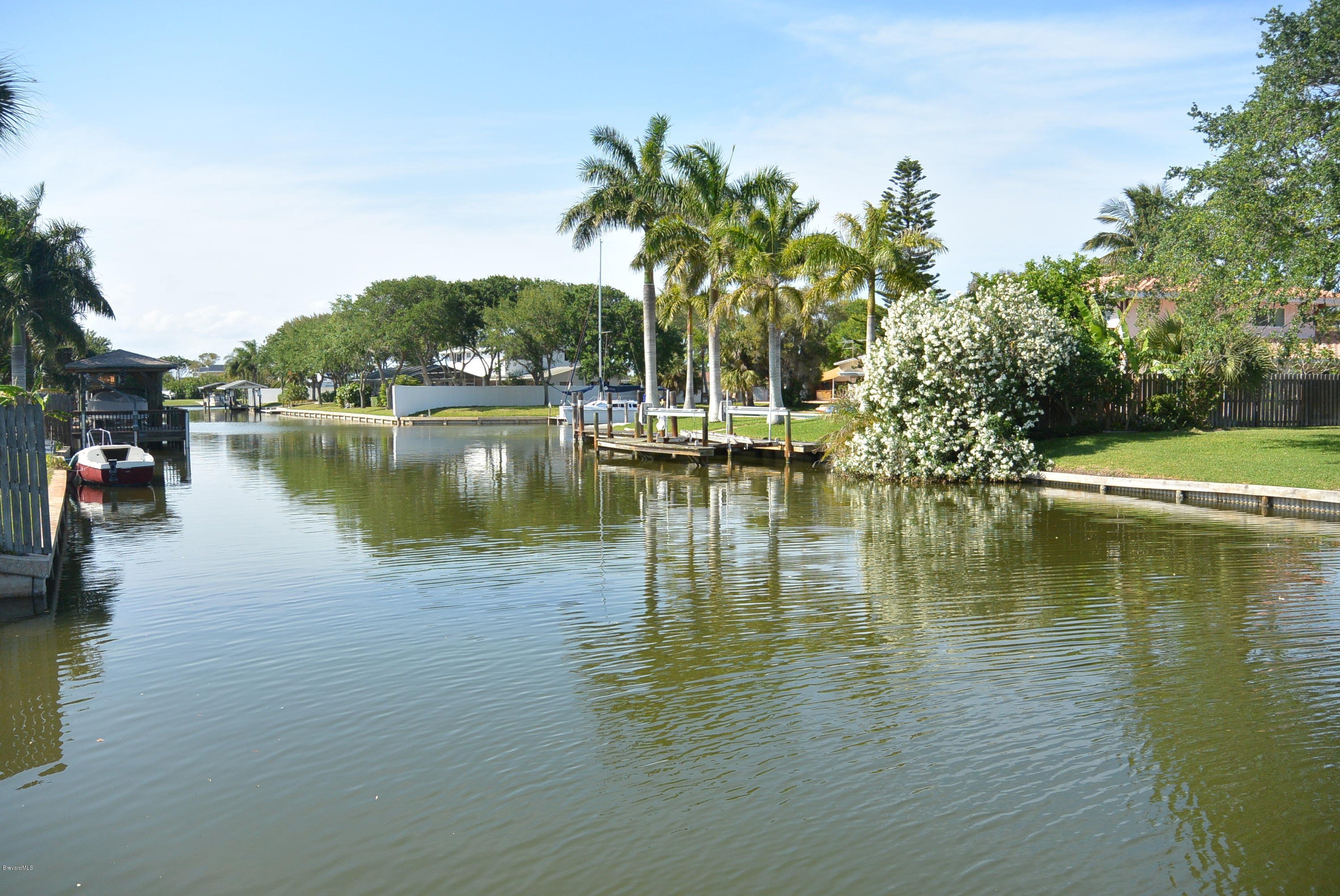 9 West Point Drive Cocoa Beach, FL 32931 - Photo 4 of 28 a view of a lake with boats and trees in the background