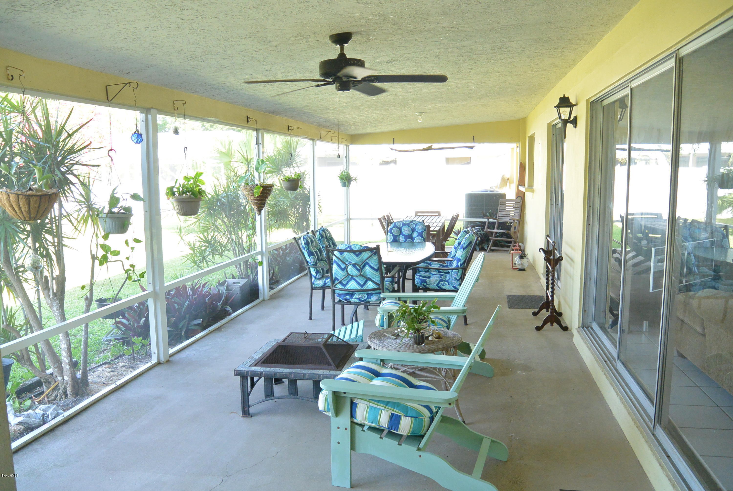 9 West Point Drive Cocoa Beach, FL 32931 - Photo 5 of 28 a living room with furniture and a floor to ceiling window