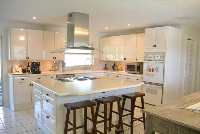 a kitchen with a stove a sink and a refrigerator