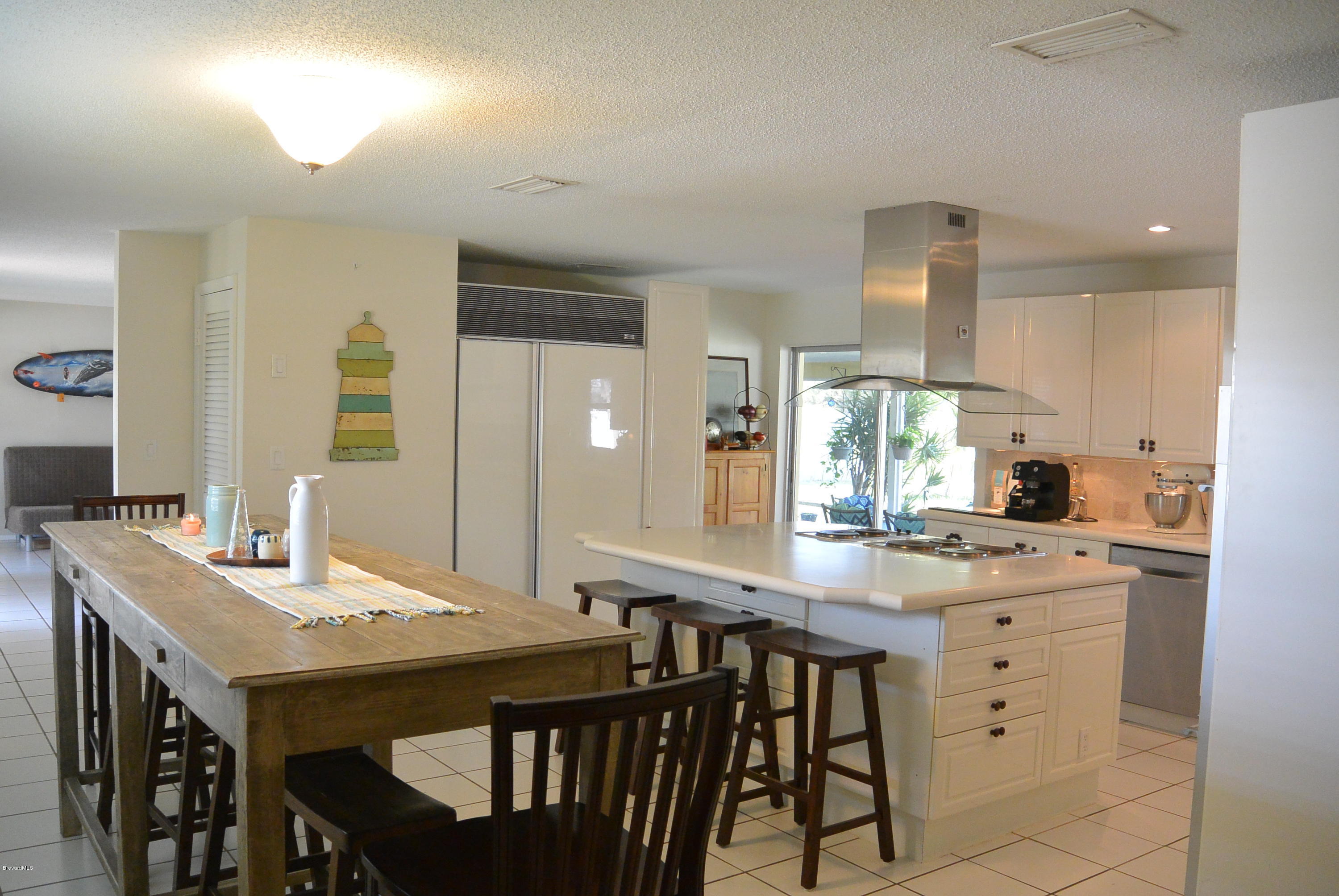 9 West Point Drive Cocoa Beach, FL 32931 - Photo 8 of 28 a kitchen with a table and chairs in it