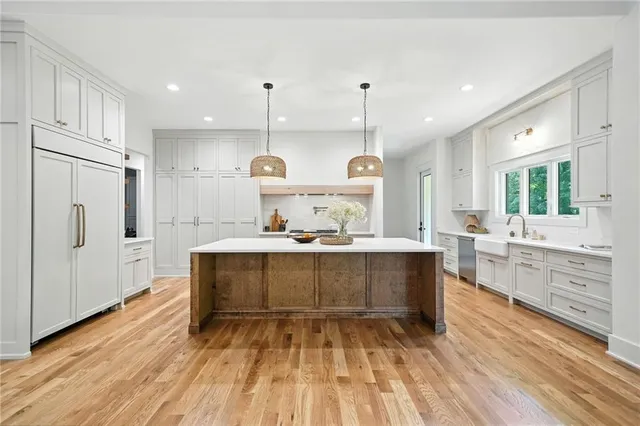 a bathroom with a toilet a sink a mirror and vanity