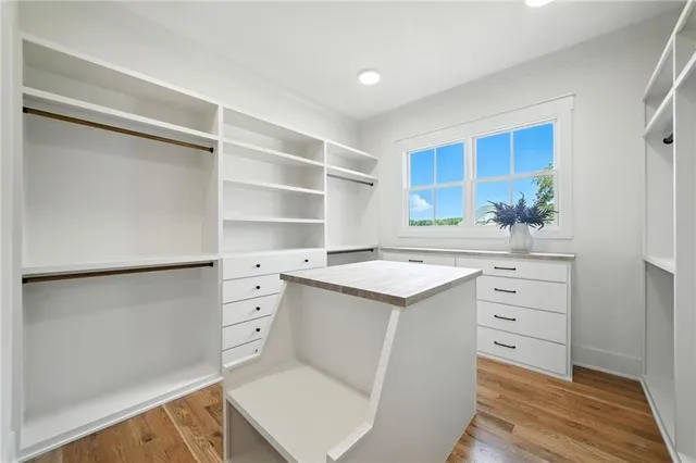 an aerial view of a house with swimming pool and large trees