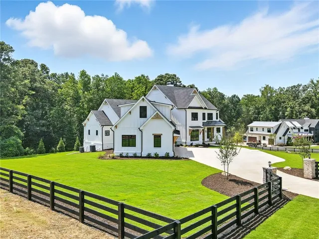 an aerial view of a house with a garden and swimming pool
