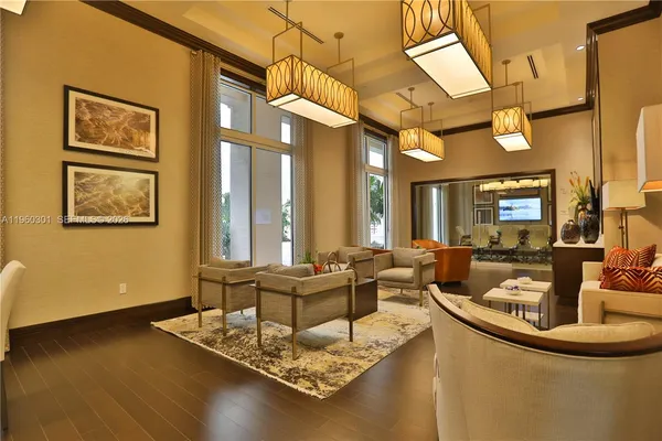 a living room with fireplace furniture and a large window