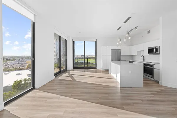a view of a kitchen with wooden floor and a window