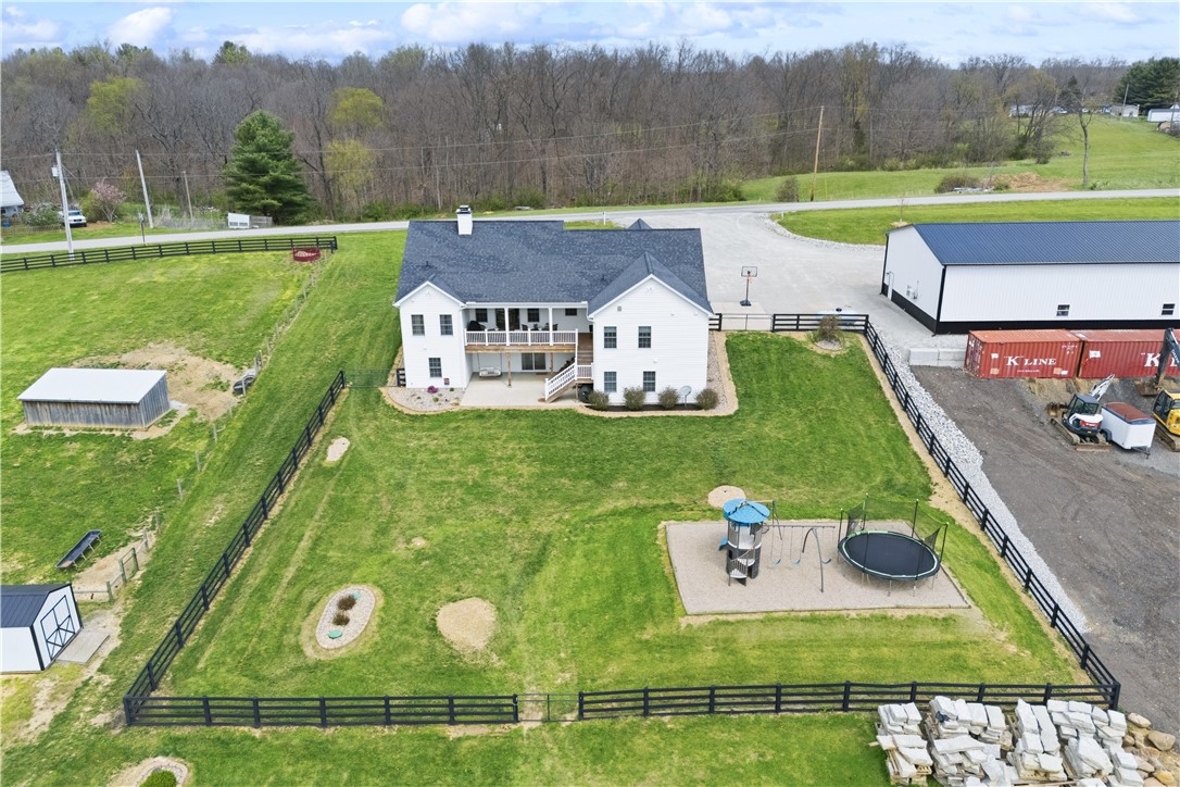 1158 Pyle Road Clarksville, OH 45113 - Photo 65 of 76 This elevated view captures a charming residence with expansive green space and nearby practical amenities.