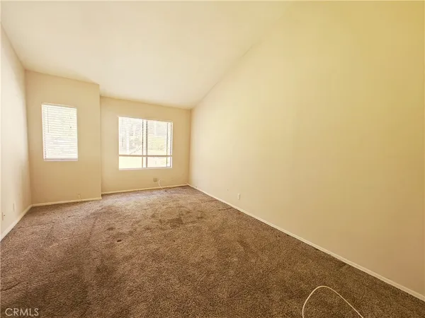 an empty room with windows and closet