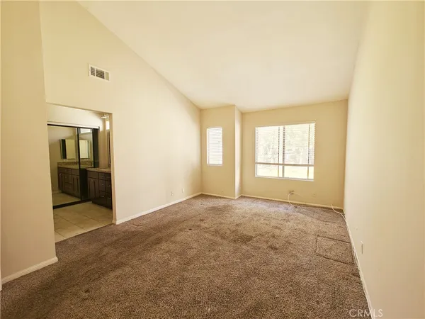 a bathroom with a granite countertop sink a mirror and a bathtub