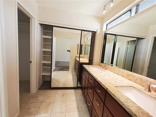 a white toilet next to a bathroom