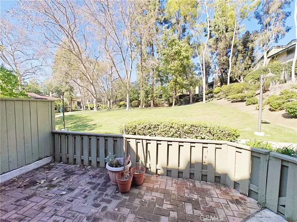 a view of a backyard with wooden fence
