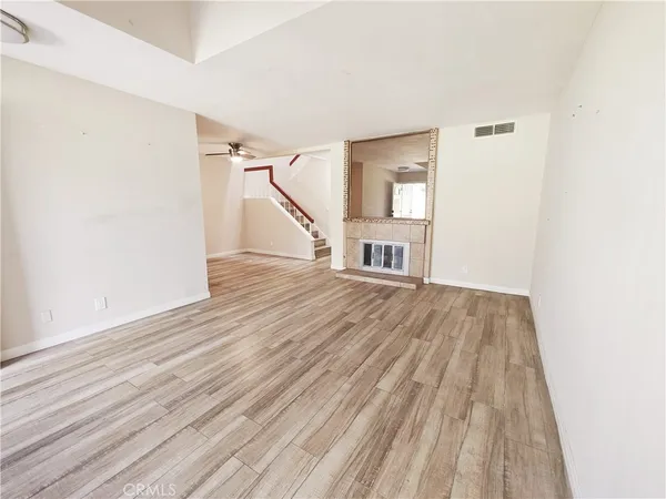 a view of empty room with wooden floor