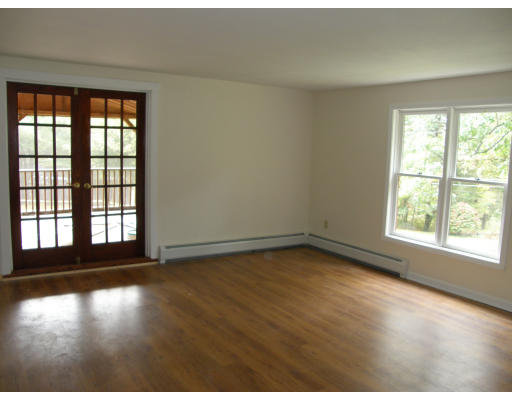 217 Brickyard Road Athol, MA 01331 - Photo 4 of 14 an empty room with wooden floor and windows