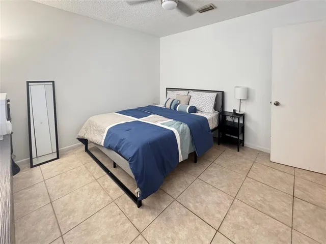 a bed room with a bed and a rug