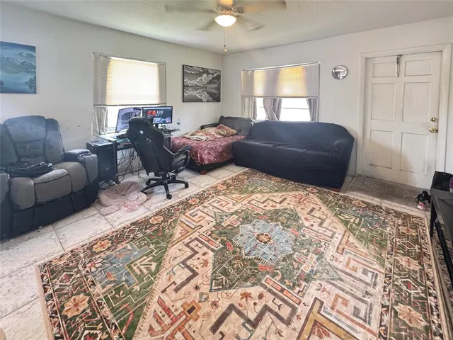 a living room with a bed furniture and a window