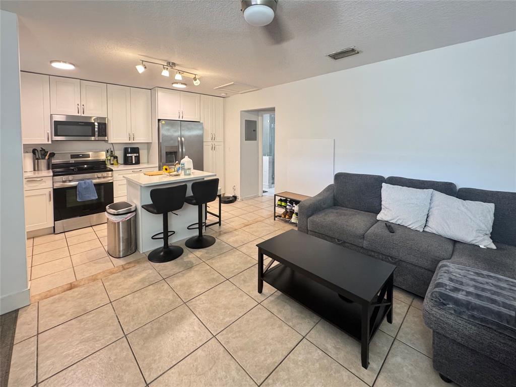 151 Southwest 15th Street Pompano Beach, FL 33060 - Photo 2 of 36 a living room with furniture and kitchen view