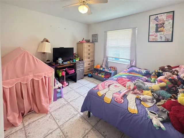 a bedroom with a bed and flat screen tv