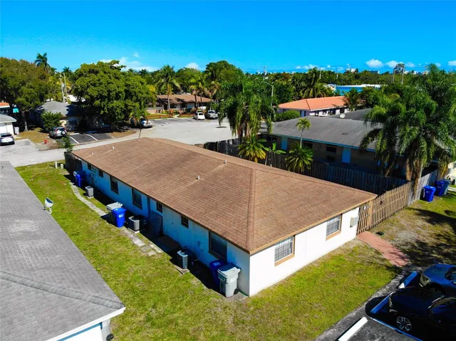 an aerial view of residential houses with outdoor space