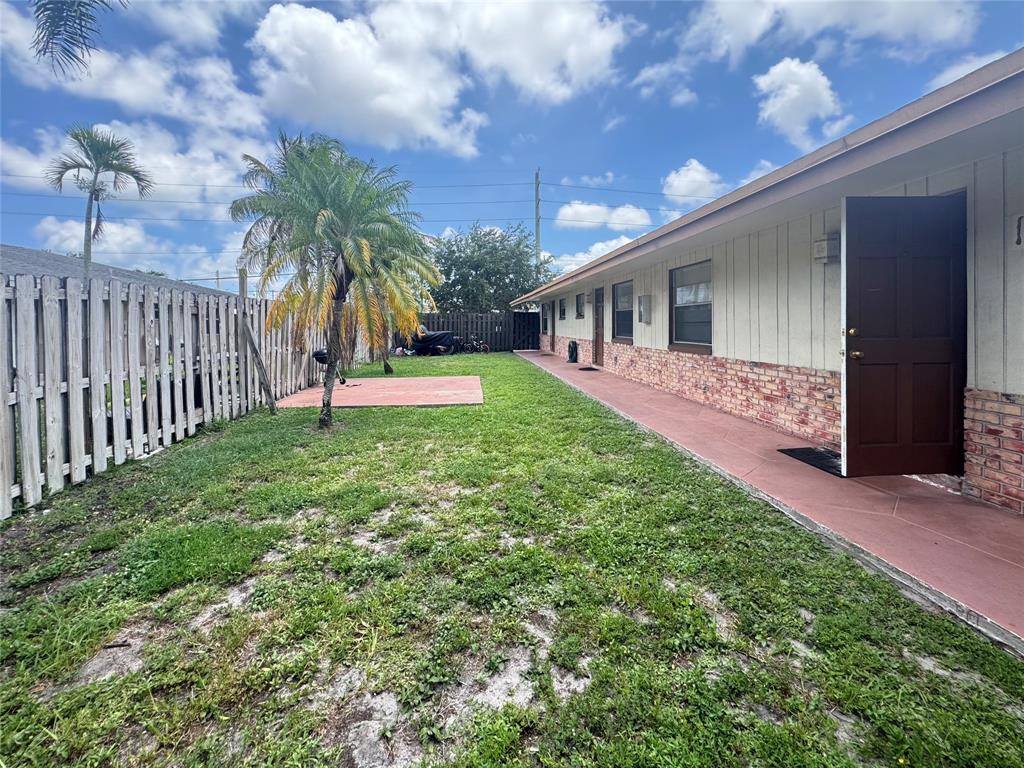 151 Southwest 15th Street Pompano Beach, FL 33060 - Photo 33 of 36 a view of a backyard with potted plants and a large tree