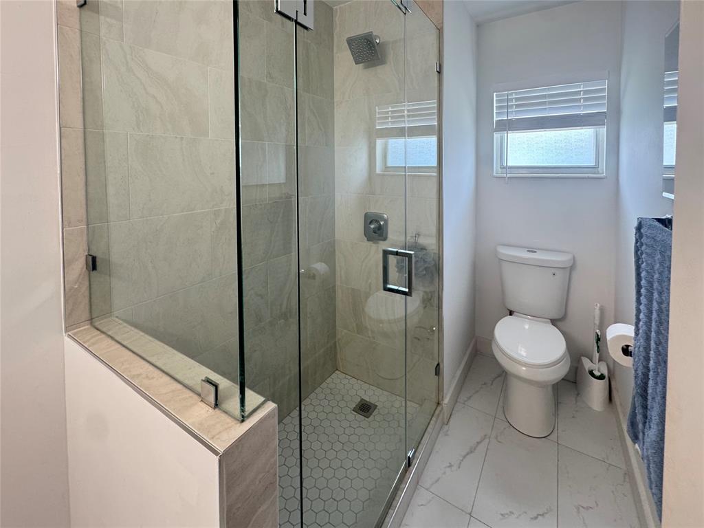 151 Southwest 15th Street Pompano Beach, FL 33060 - Photo 5 of 36 a bathroom with a toilet a sink and shower