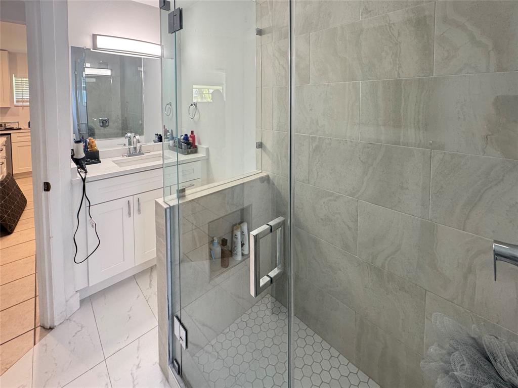 151 Southwest 15th Street Pompano Beach, FL 33060 - Photo 7 of 36 a bathroom with a sink mirror and shower