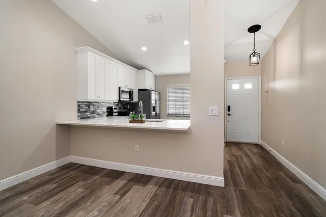a view of kitchen with wooden floor and window