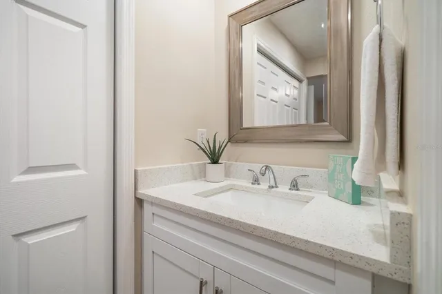 a bathroom with a sink vanity and mirror