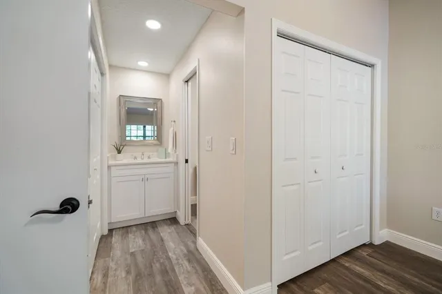 a view of a hallway with wooden floor
