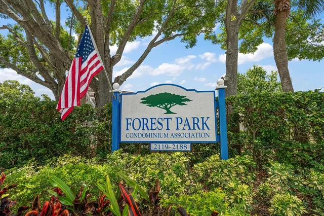 a sign that is sitting in front of flowers