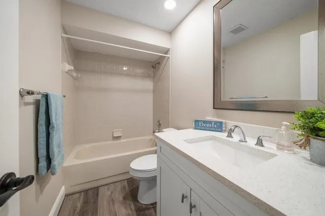 a bathroom with a sink toilet tub and shower