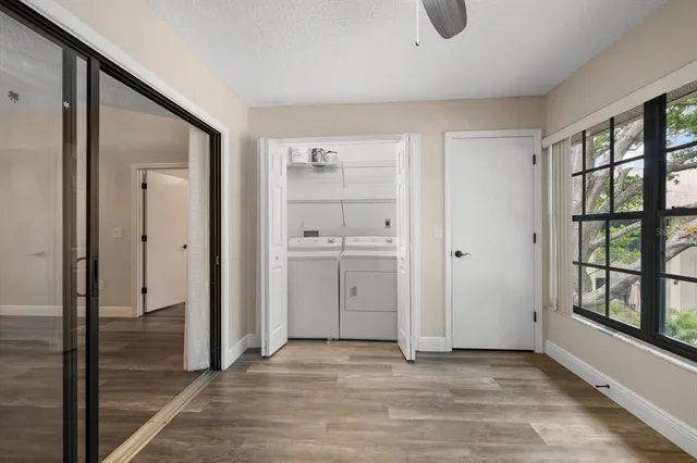 a view of empty room with window and wooden floor