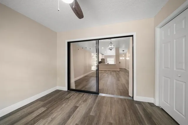 a view of empty room with wooden floor