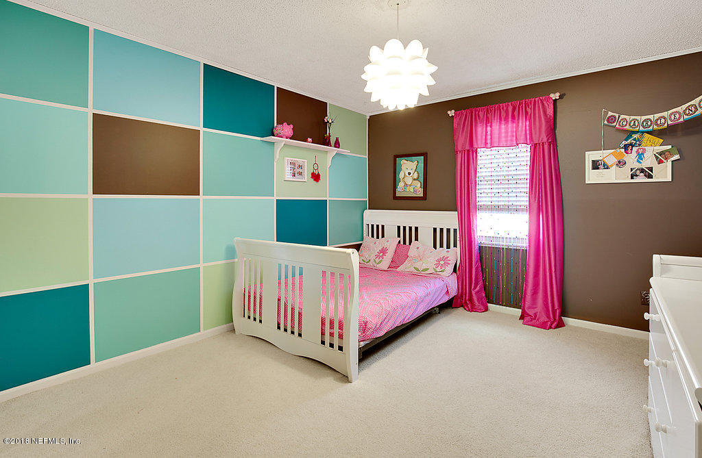 1866 Clemson Road Jacksonville, FL 32217 - Photo 13 of 21 a bedroom with a bed and window