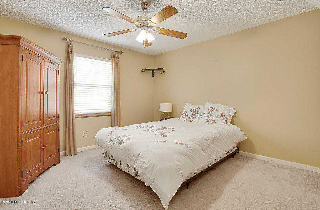 1866 Clemson Road Jacksonville, FL 32217 - Photo 14 of 21 a bedroom with a bed and a window