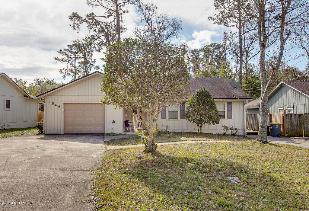 1866 Clemson Road Jacksonville, FL 32217 - Photo 2 of 21 a view of a house with a yard covered in snow