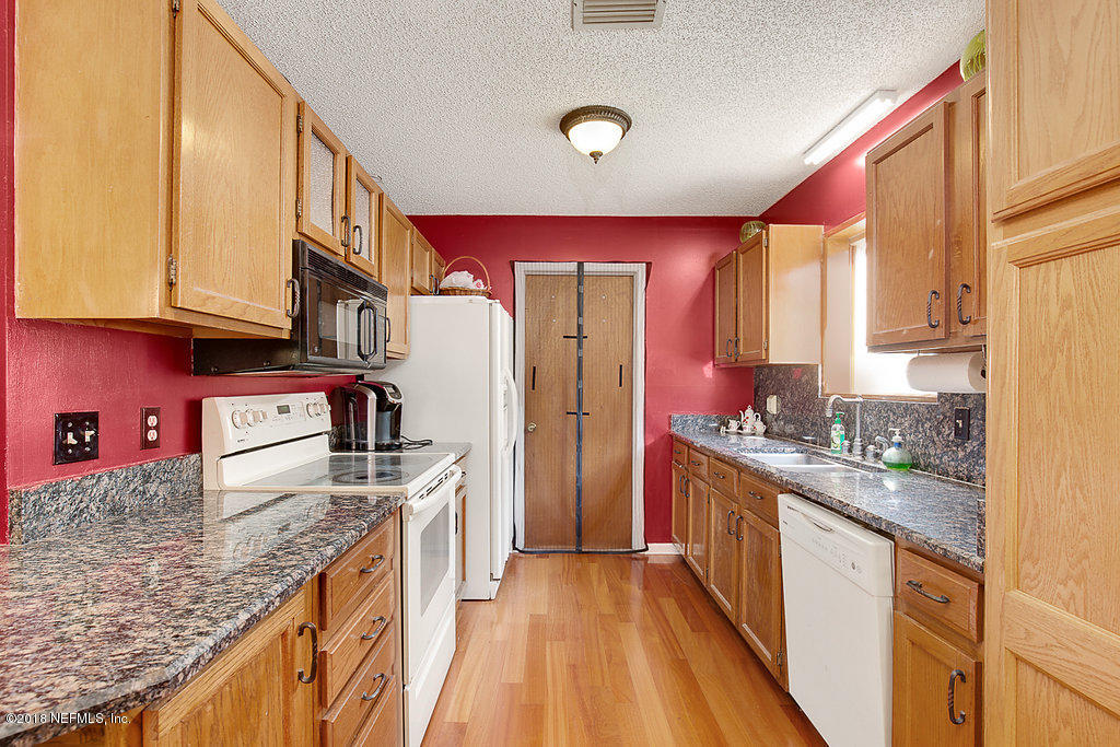 1866 Clemson Road Jacksonville, FL 32217 - Photo 8 of 21 a kitchen with stainless steel appliances granite countertop a stove a sink and a refrigerator