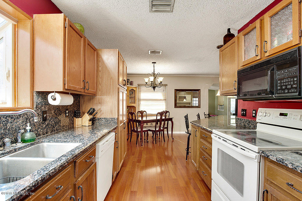1866 Clemson Road Jacksonville, FL 32217 - Photo 9 of 21 a kitchen with granite countertop lots of counter top space and dining table