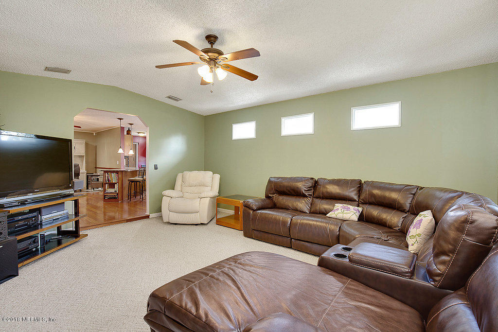 1866 Clemson Road Jacksonville, FL 32217 - Photo 10 of 21 a living room with furniture and a flat screen tv