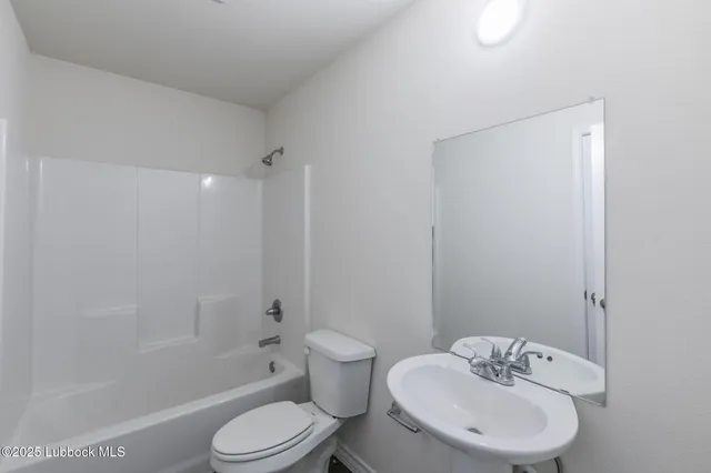 a bathroom with a toilet sink and shower