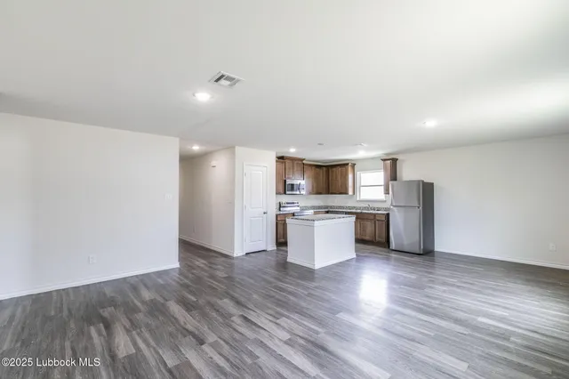 a view of kitchen with stainless steel appliances refrigerator microwave and stove