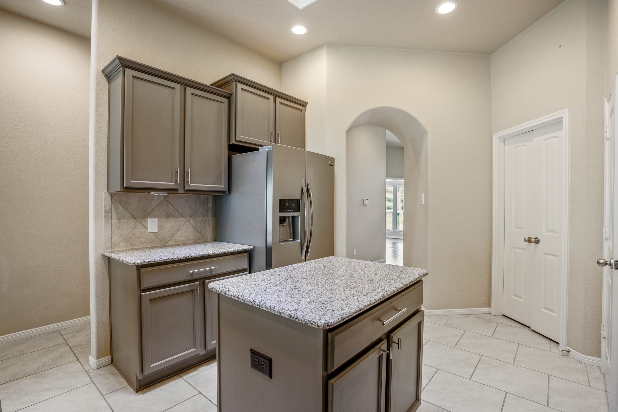 5319 Claymore Meadow Lane Spring, TX 77389 - Photo 12 of 34 a kitchen with stainless steel appliances granite countertop a table and a refrigerator