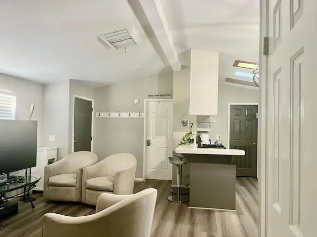 a living room with furniture and wooden floor