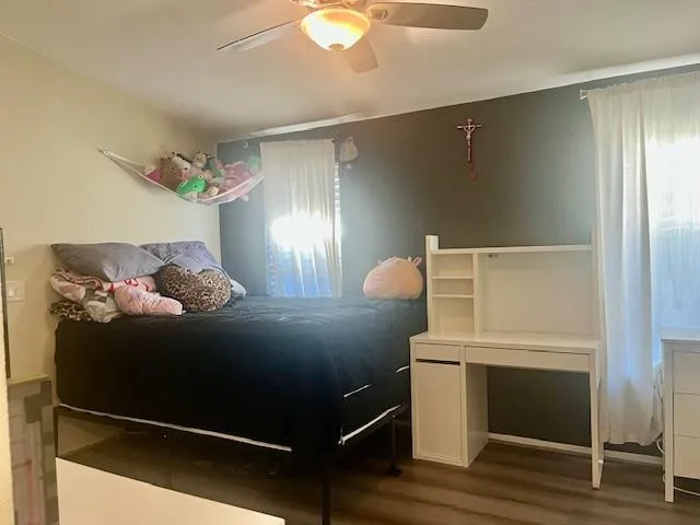 a bed sitting in a bedroom next to a window