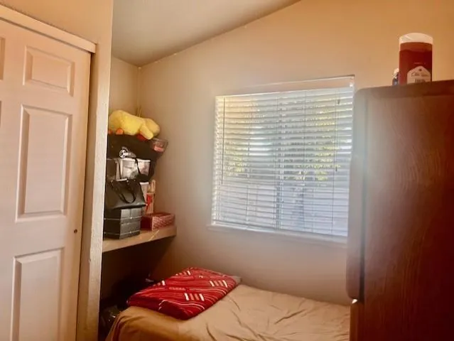 a bedroom with a bed and a window