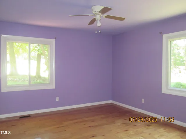 a view of a livingroom with wooden floor and cabinet
