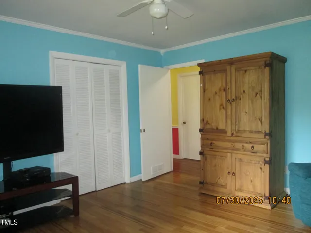 a view of a room with wooden floor and windows